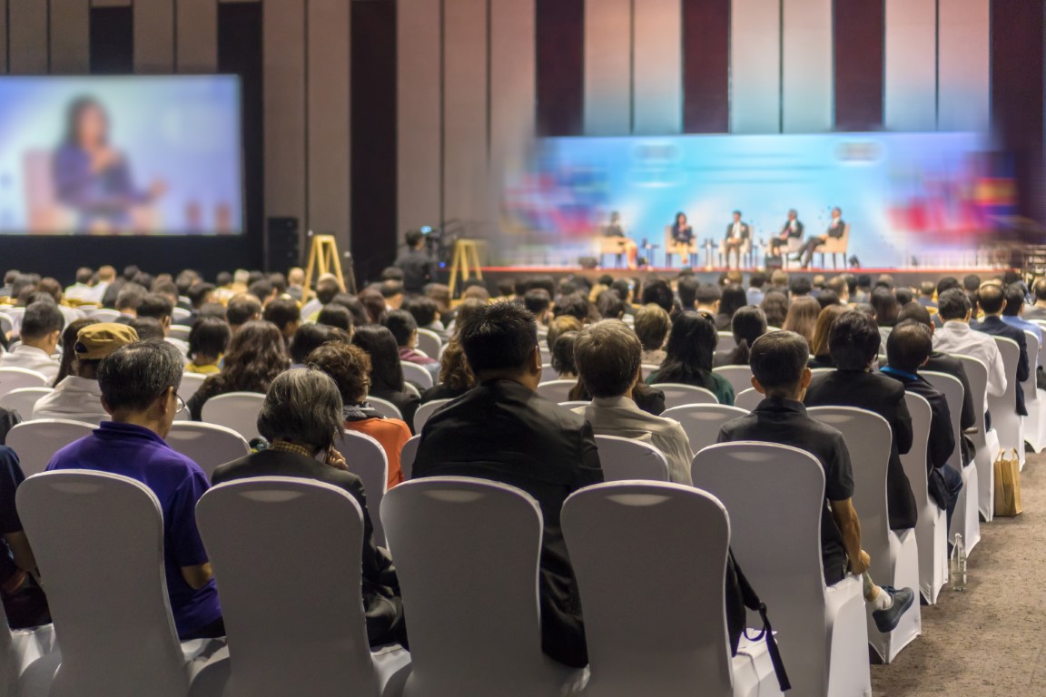 Rear view of Audience listening Speakers on the stage in the conference hall or seminar meeting, business and education about investment concept