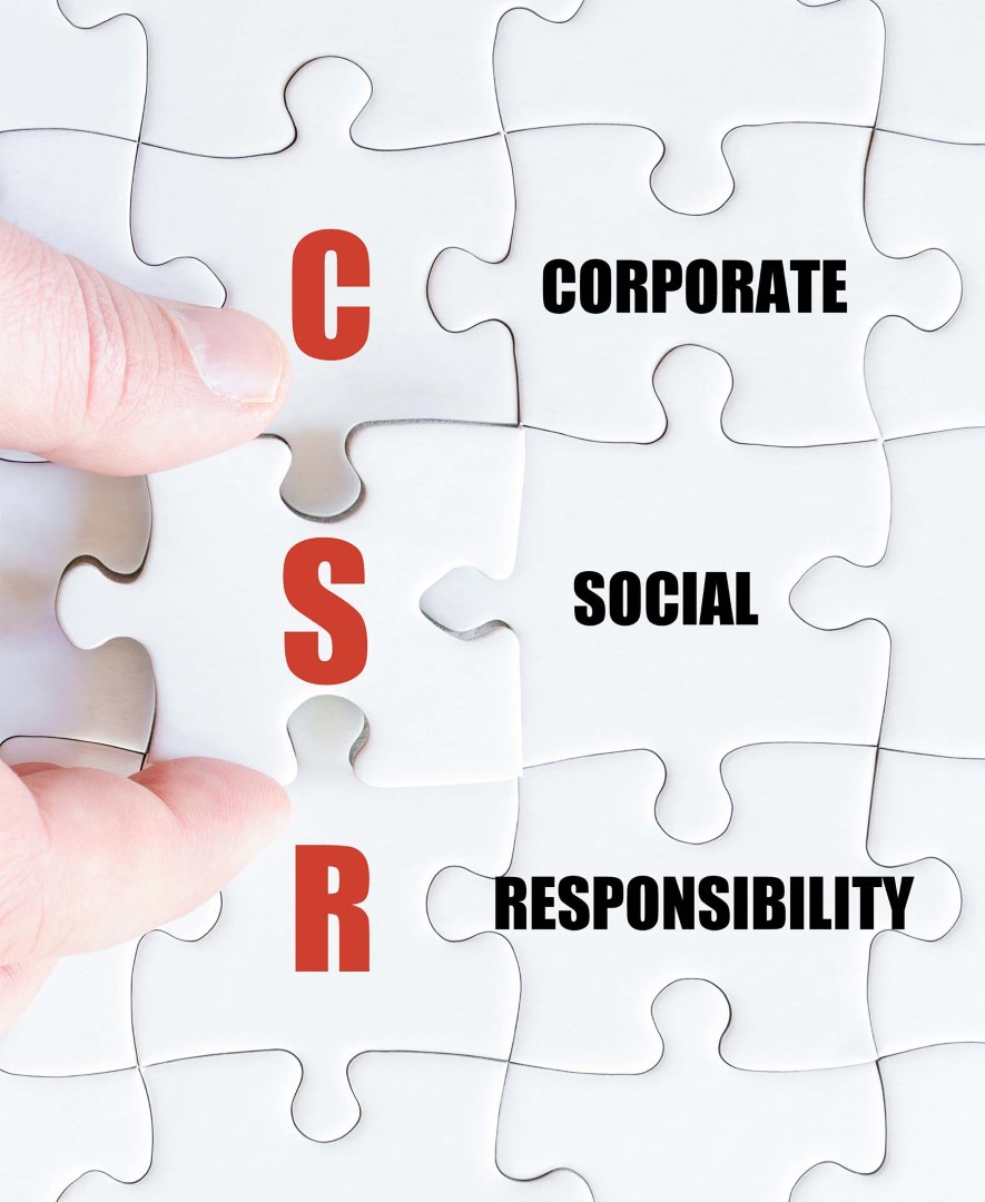 Hand of a business man completing the puzzle with the last missing piece.Concept image of Business Acronym CSR as Corporate Social Responsibility